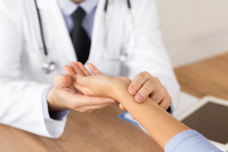 Image of a healthcare professional examining a patient's wrist